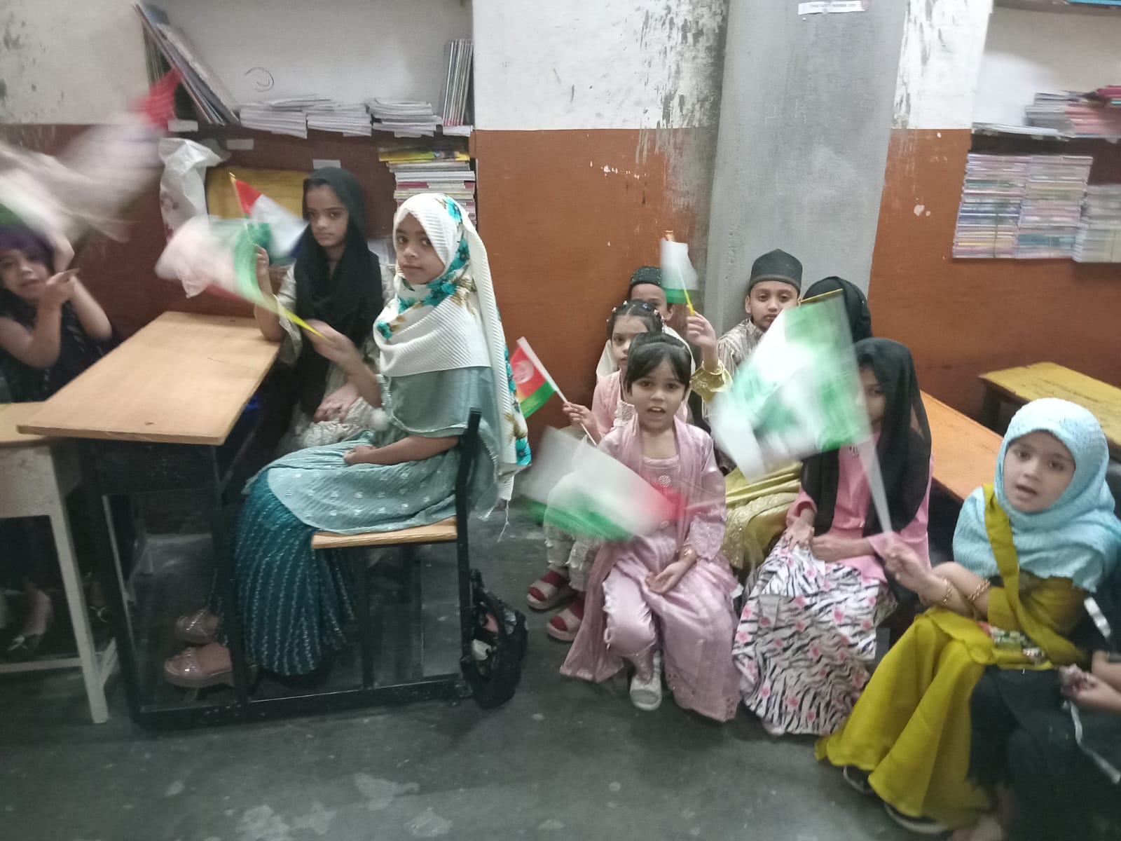 Children waving flags in desks